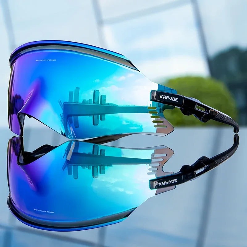 Velovoila KAPVOE UV400 cycling sunglasses featuring a reflective blue shield lens and aerodynamic black frame.