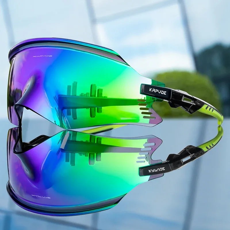 Velovoila KAPVOE cycling sunglasses featuring a reflective green and purple one-piece shield lens with black frame